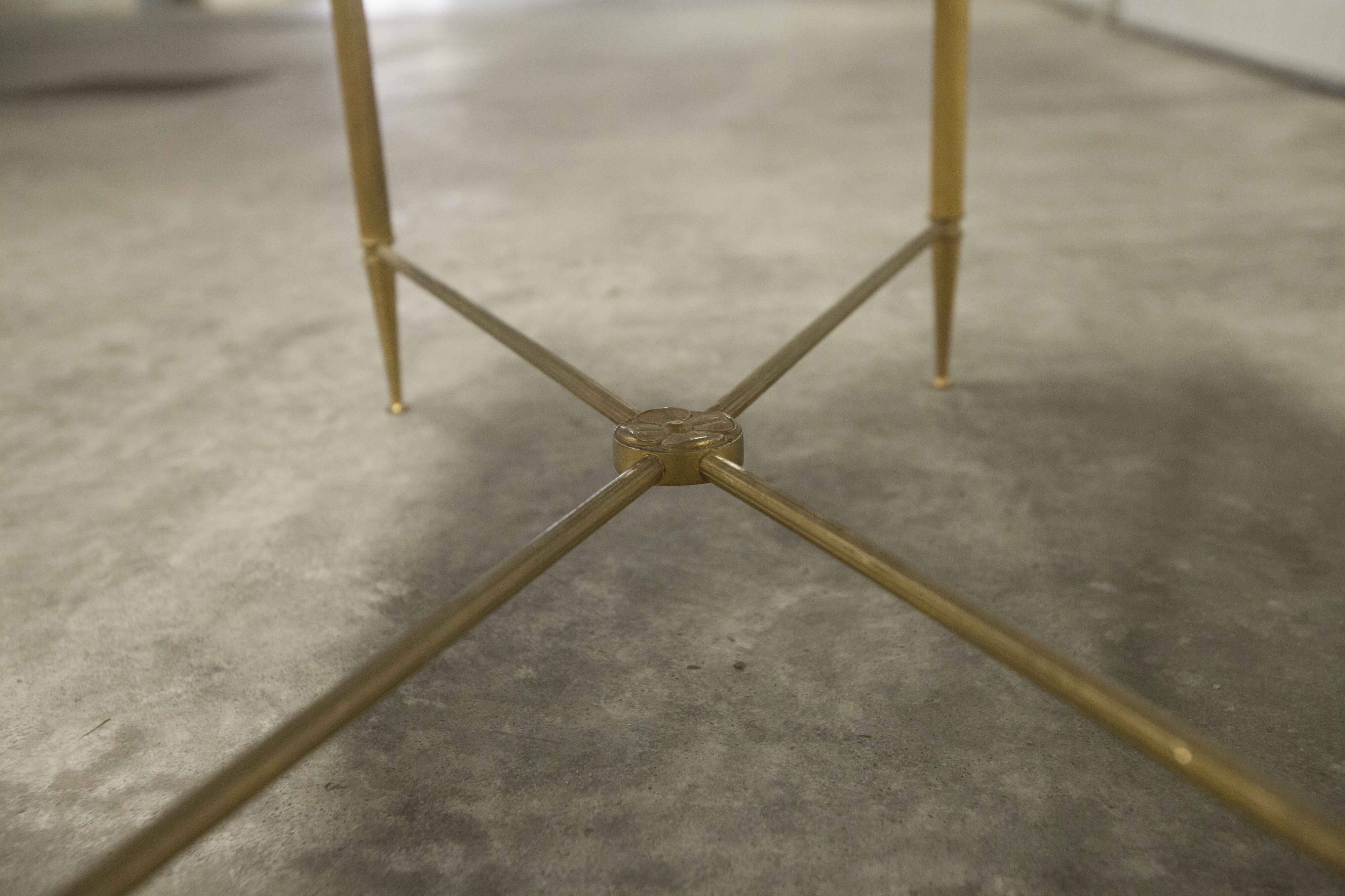 Marble coffee table with brass legs, height 46 cm.