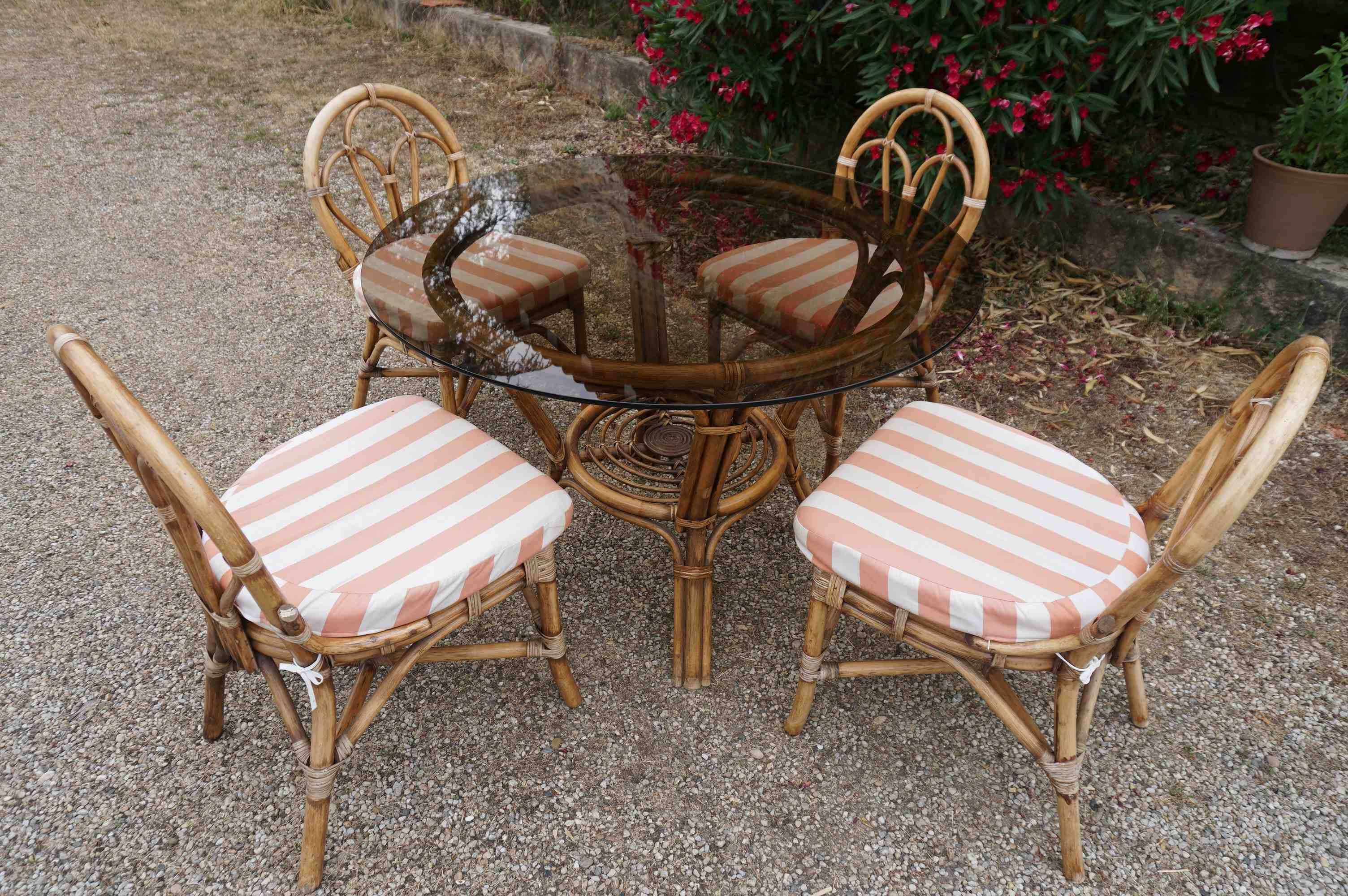 dining table and chairs made of curved bamboo and rattan with smoked glass from the 1970s