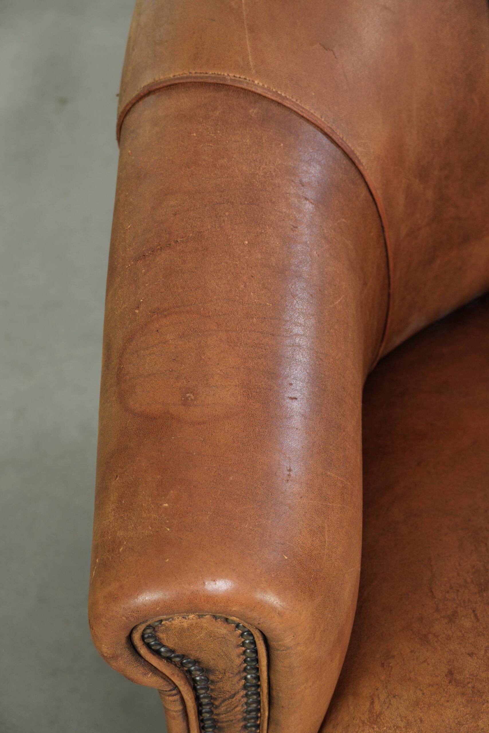 Aged sheepskin clubchair with beautiful vintage patina and comfortable seat