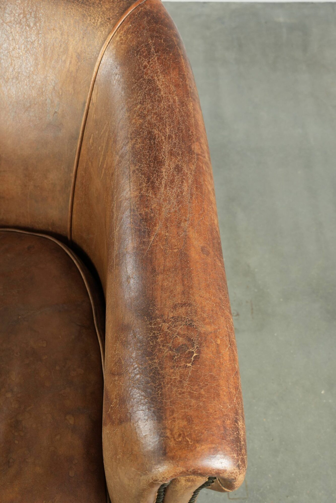 Vintage sheepskin club armchair finished with decorative nails