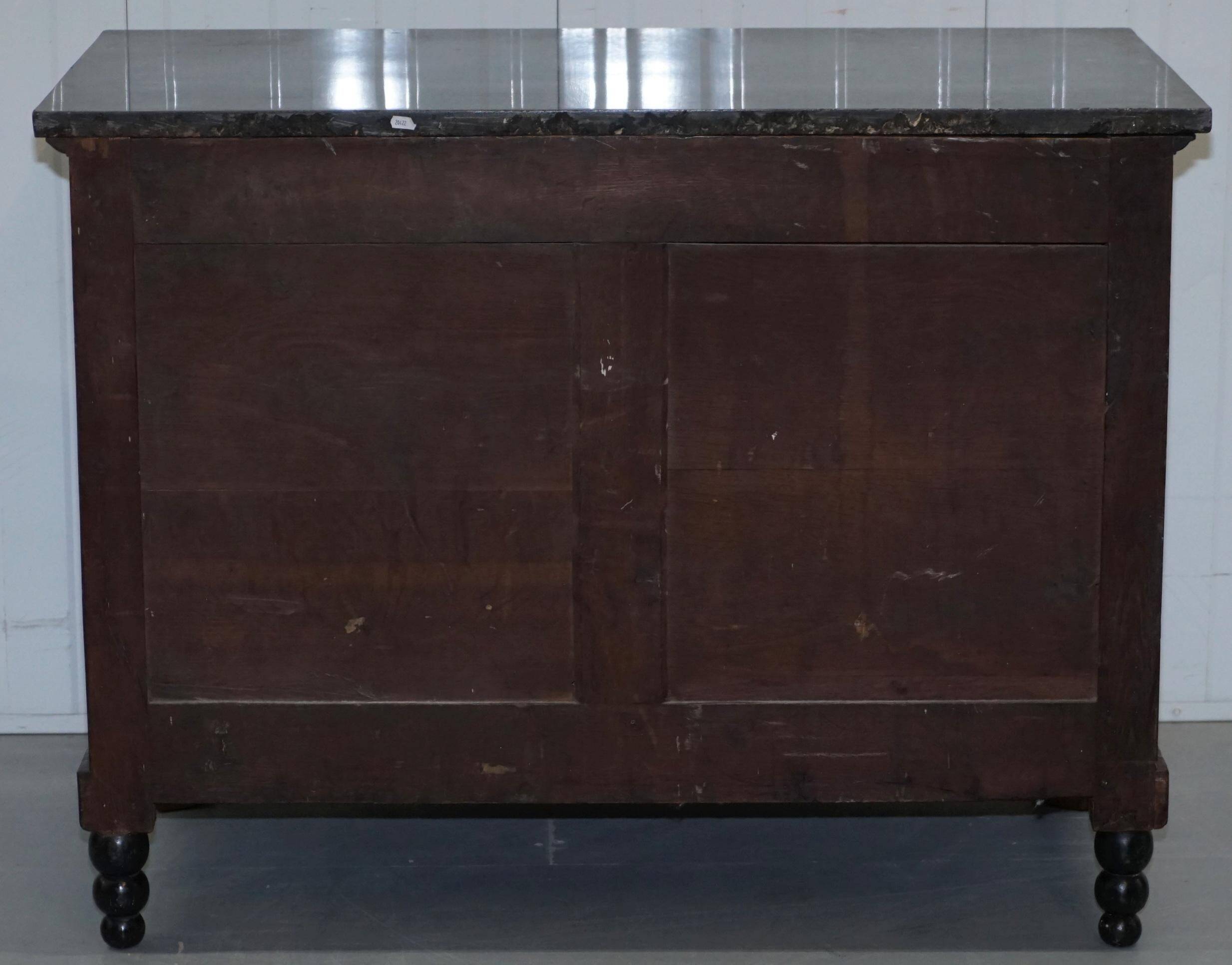 19th-century Empire commode with a marble top and lion paw feet.