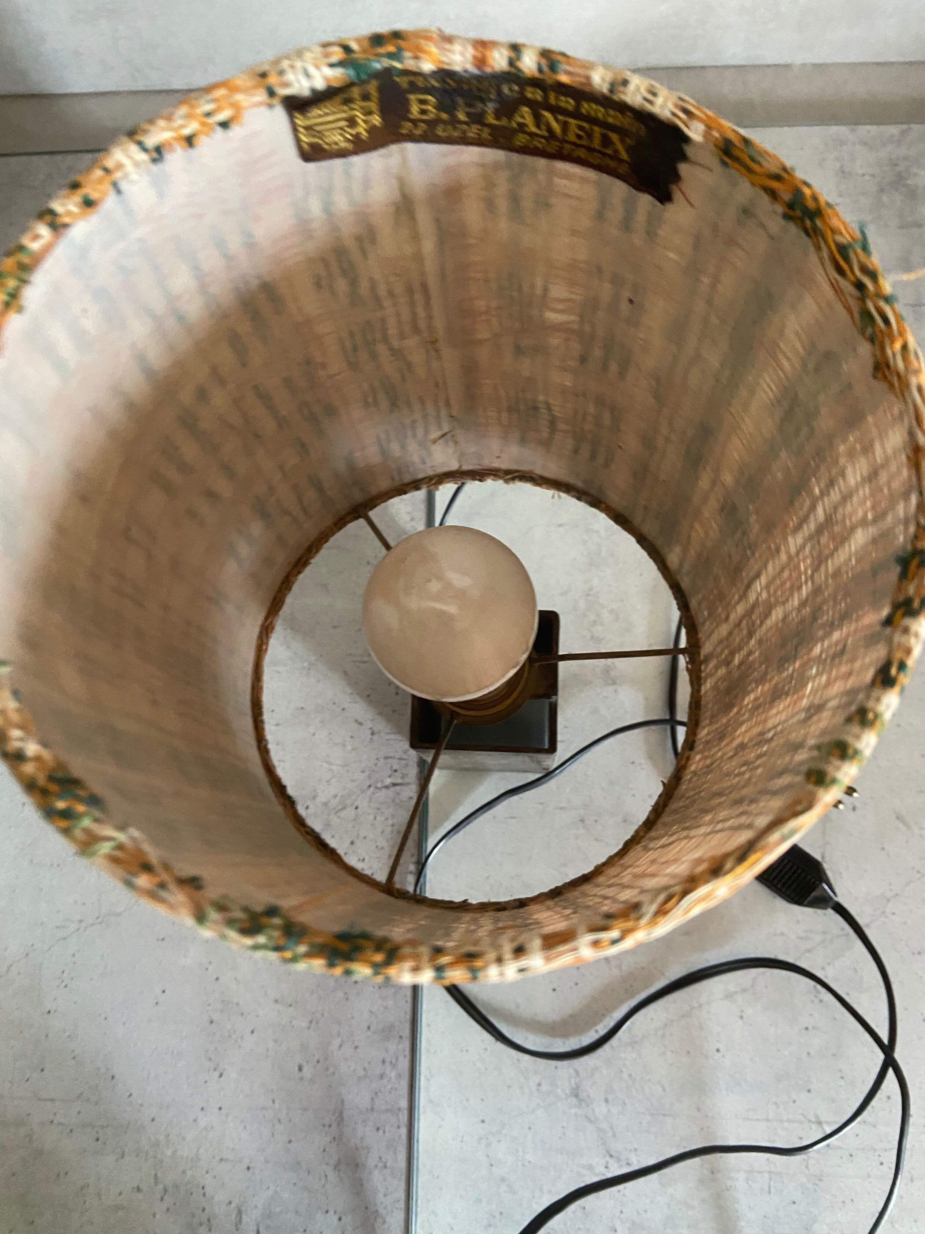 Small modernist table lamp with hand-woven shade.