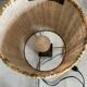 Small modernist table lamp with hand-woven shade.