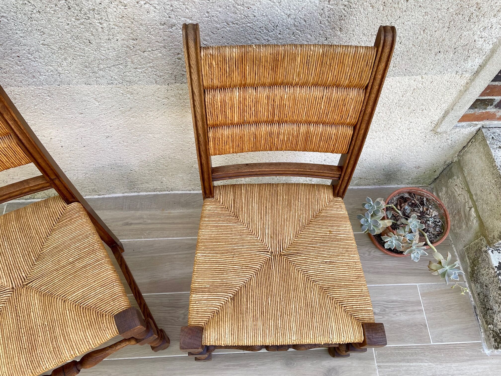 Pair of straw and solid oak chairs