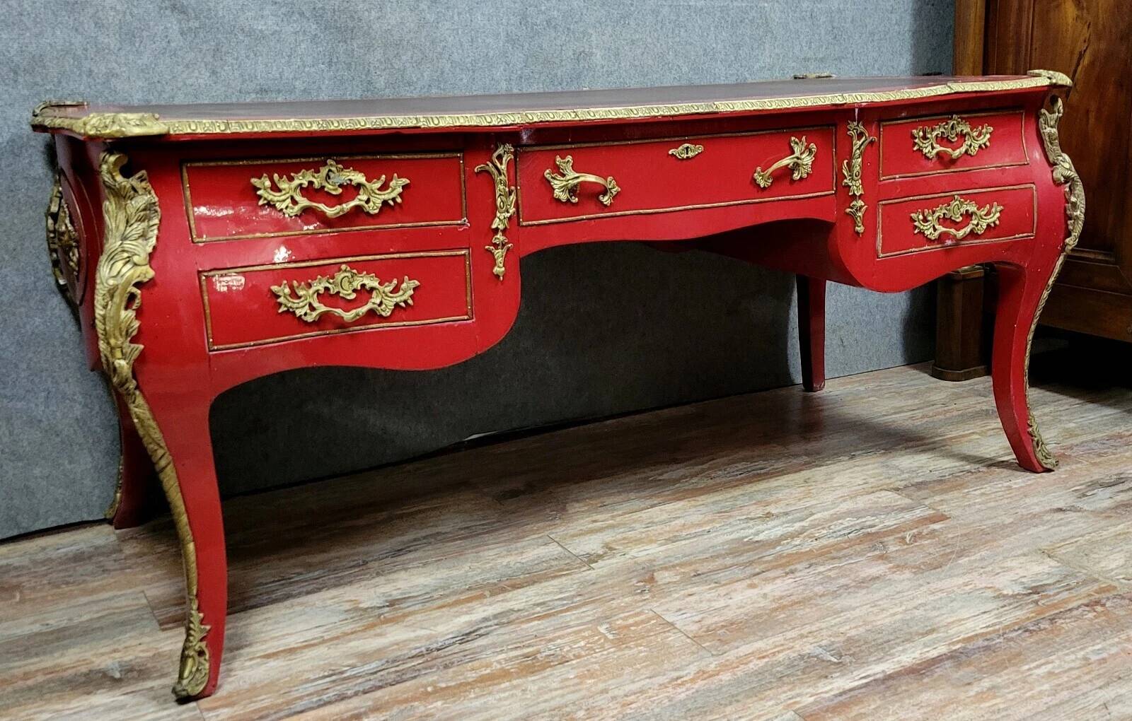 Louis XV style curved center desk in red lacquer and gilded bronze