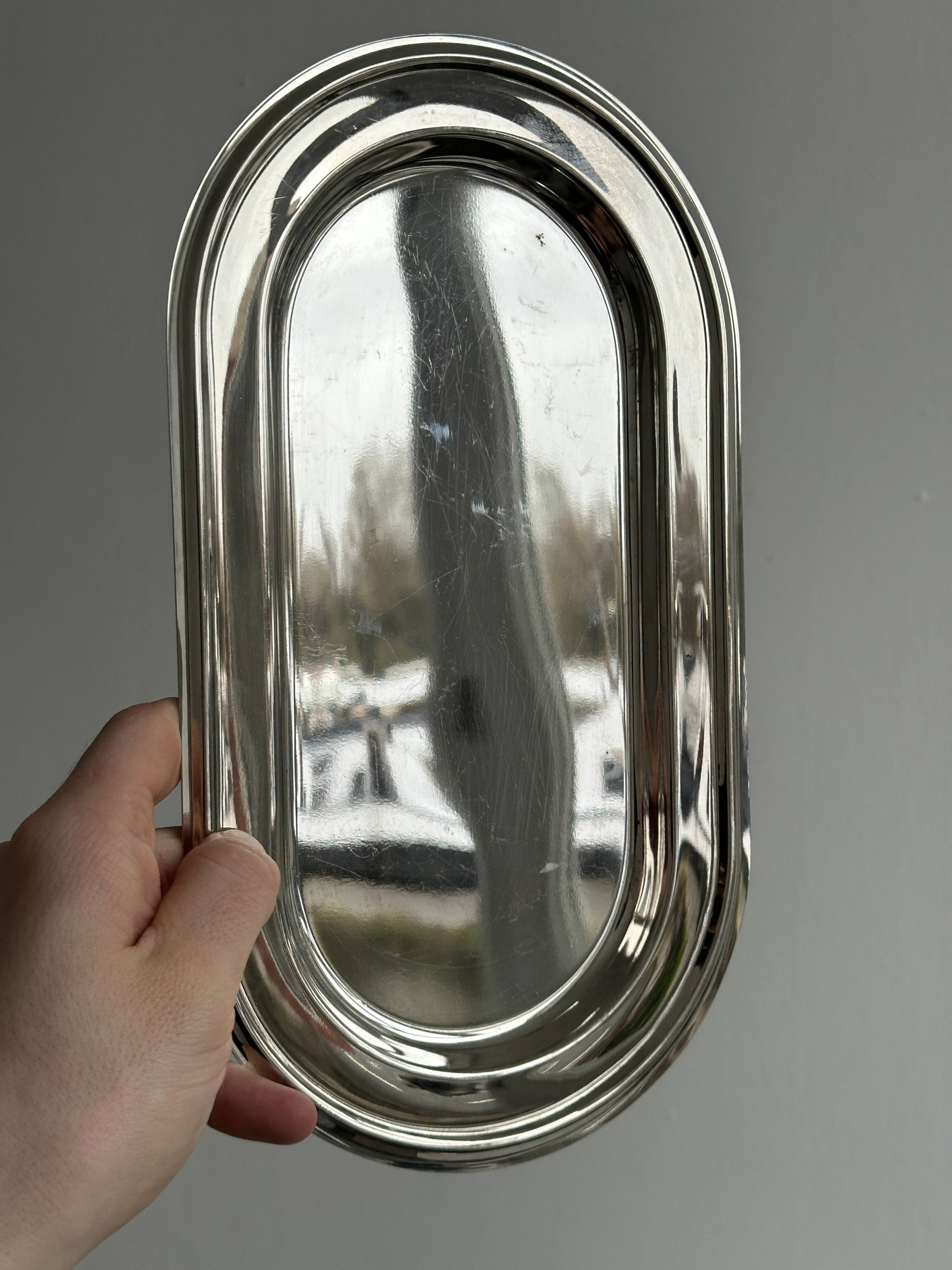 Small oval tray in shiny lightweight metal.