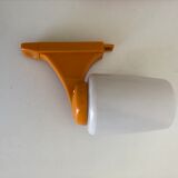 Tilting orange plastic mirror with its matching wall light