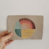 Rainbow embroidery on rag paper