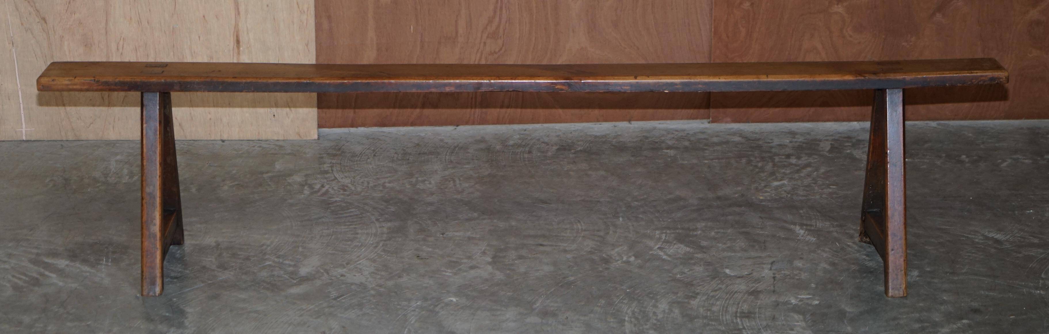 Pair of antique Victorian trestle benches in fruitwood.