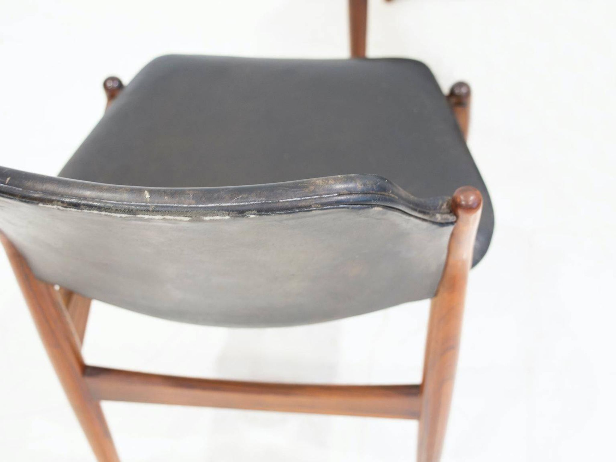 Set of four Arne Vodder chairs in hardwood and black leather.