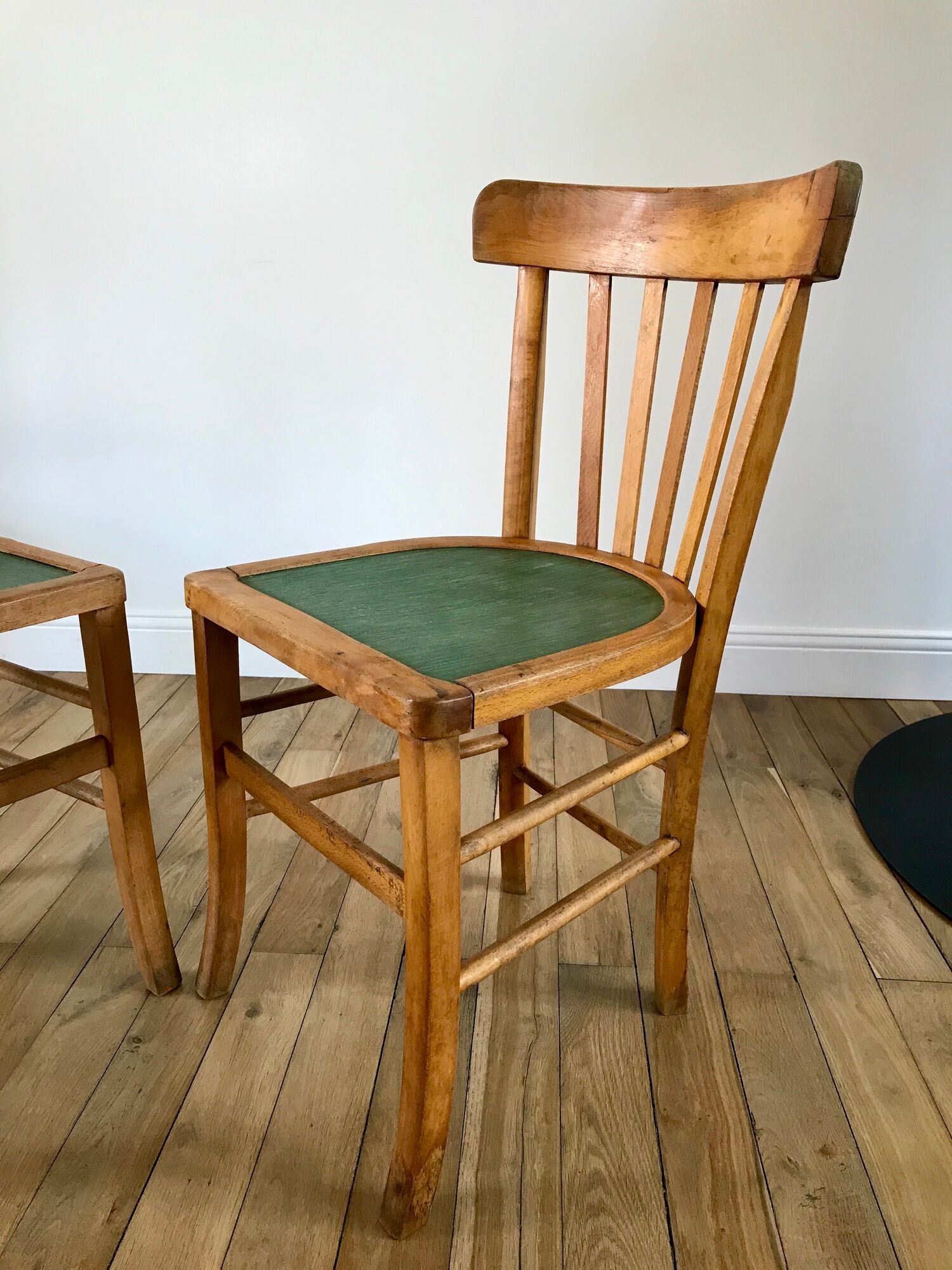 Pair of bistro chairs in light curved wood and green seat 1950s