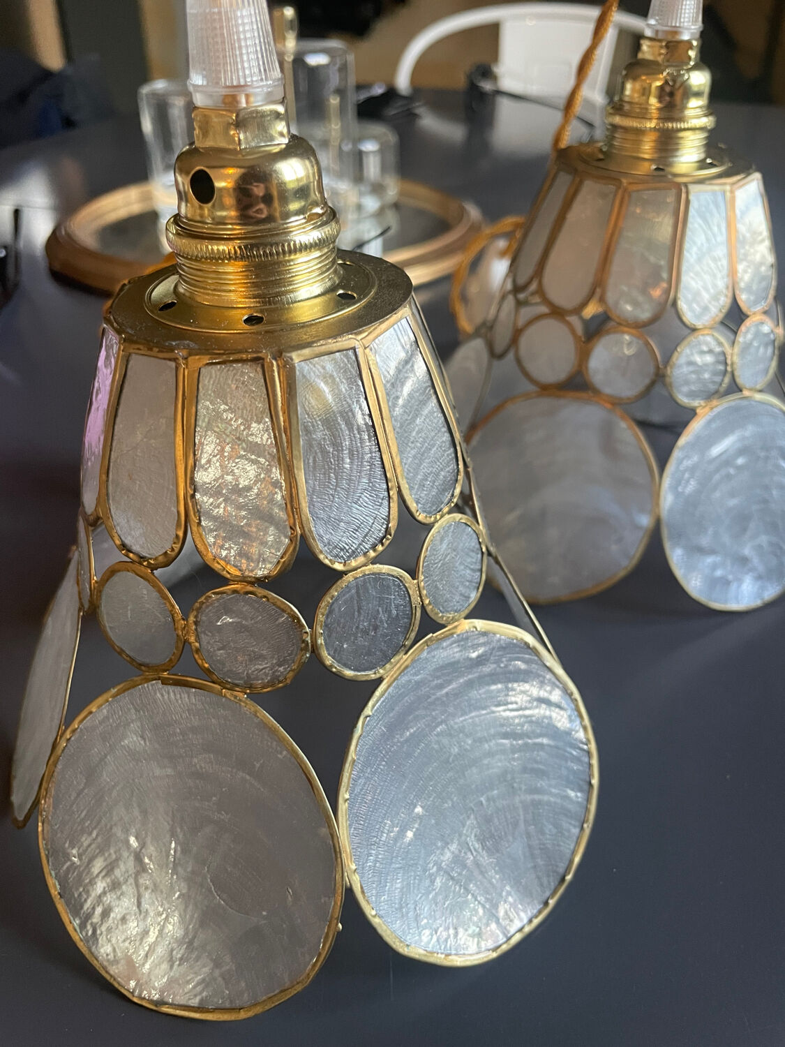 Pair of portable lamps with mother-of-pearl lampshades and brass.