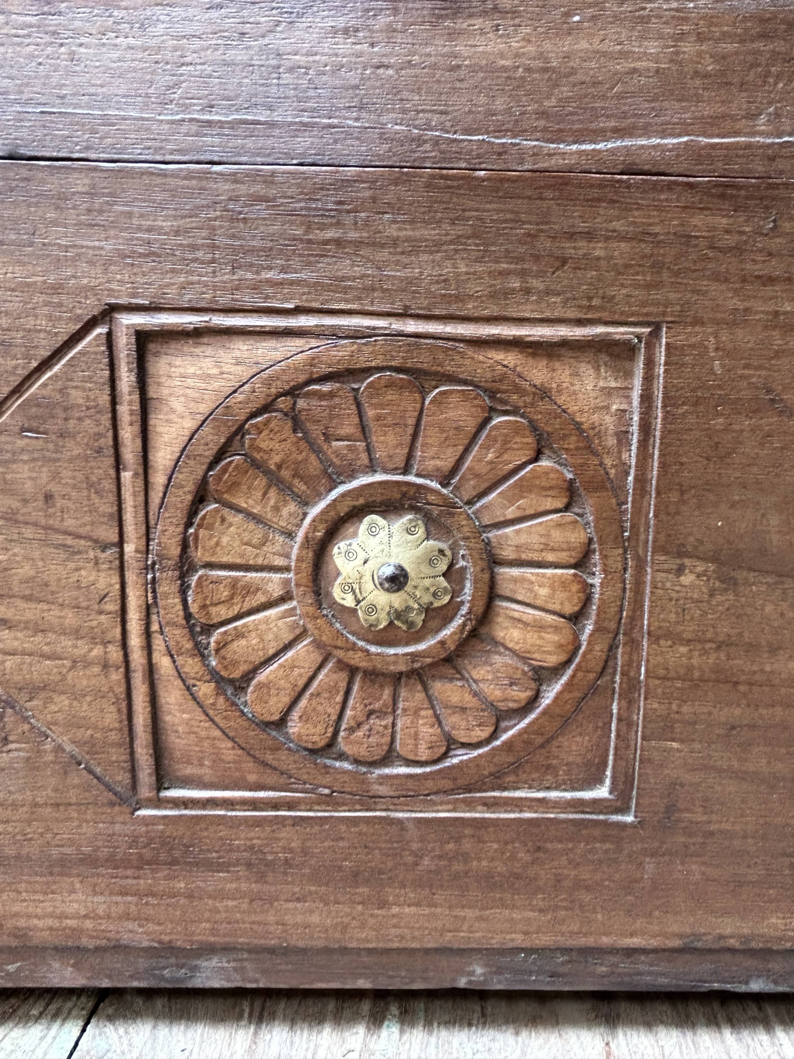 Teak chest from Burma with carved rosettes.