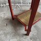 Vintage terracotta-red metal side table with glazed brown-green ceramic tile surfaces