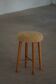 Danish sculptural stool from the mid-century modern period with a lambswool seat, 1960s.