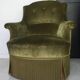 Olive green toad armchair with smooth velvet fringes.