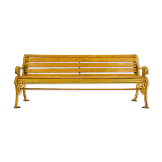 Wooden bench and yellow patina cast iron