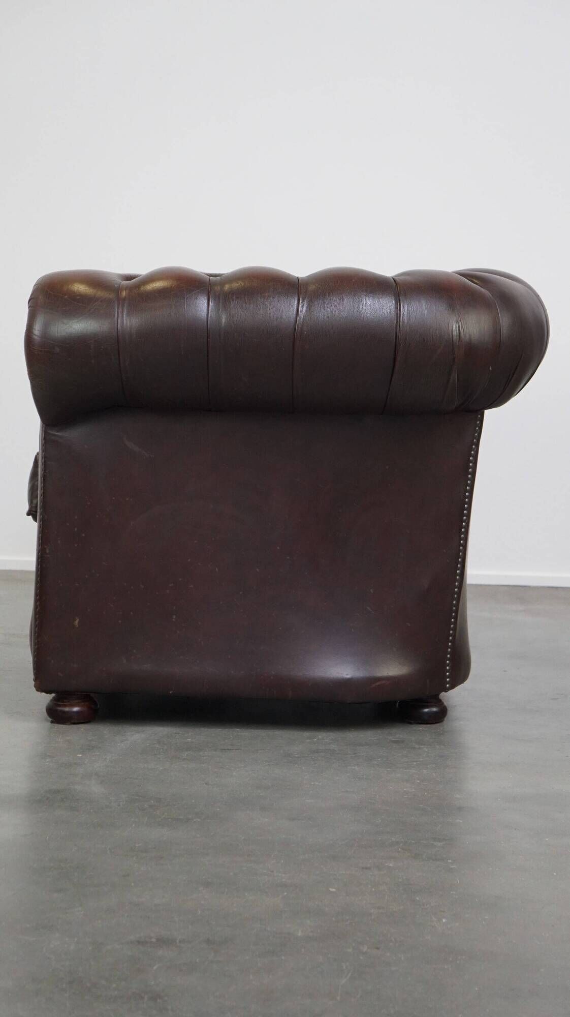 Beautiful and spacious dark brown mottled English cow leather Chesterfield armchair