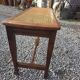 Beechwood piano bench with caning on the seat