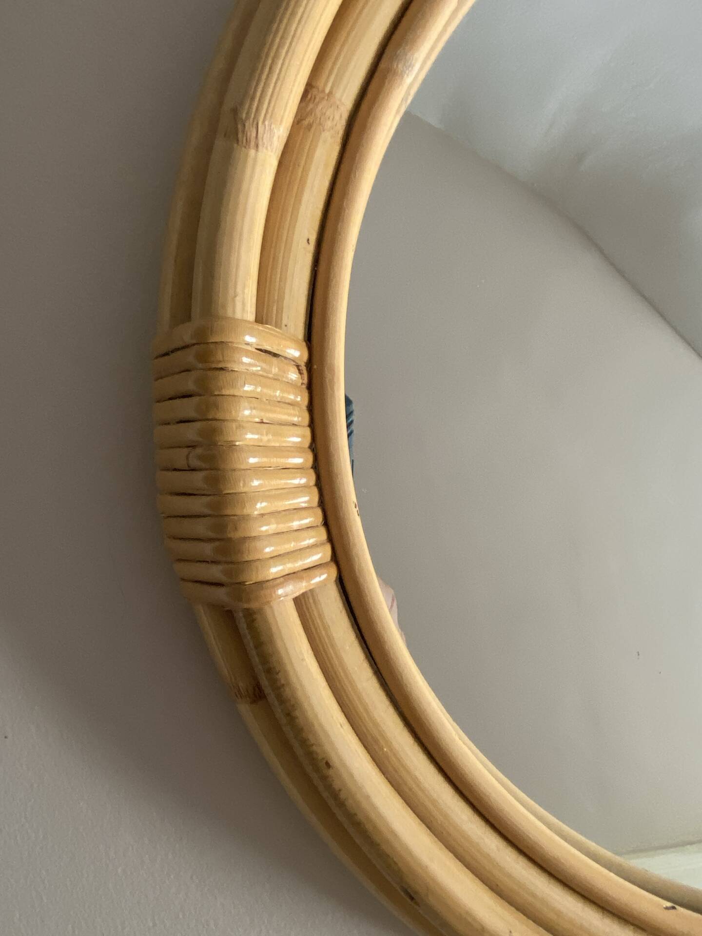 Round mirror from the 1960s with a frame made of rattan and metal.