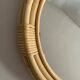 Round mirror from the 1960s with a frame made of rattan and metal.