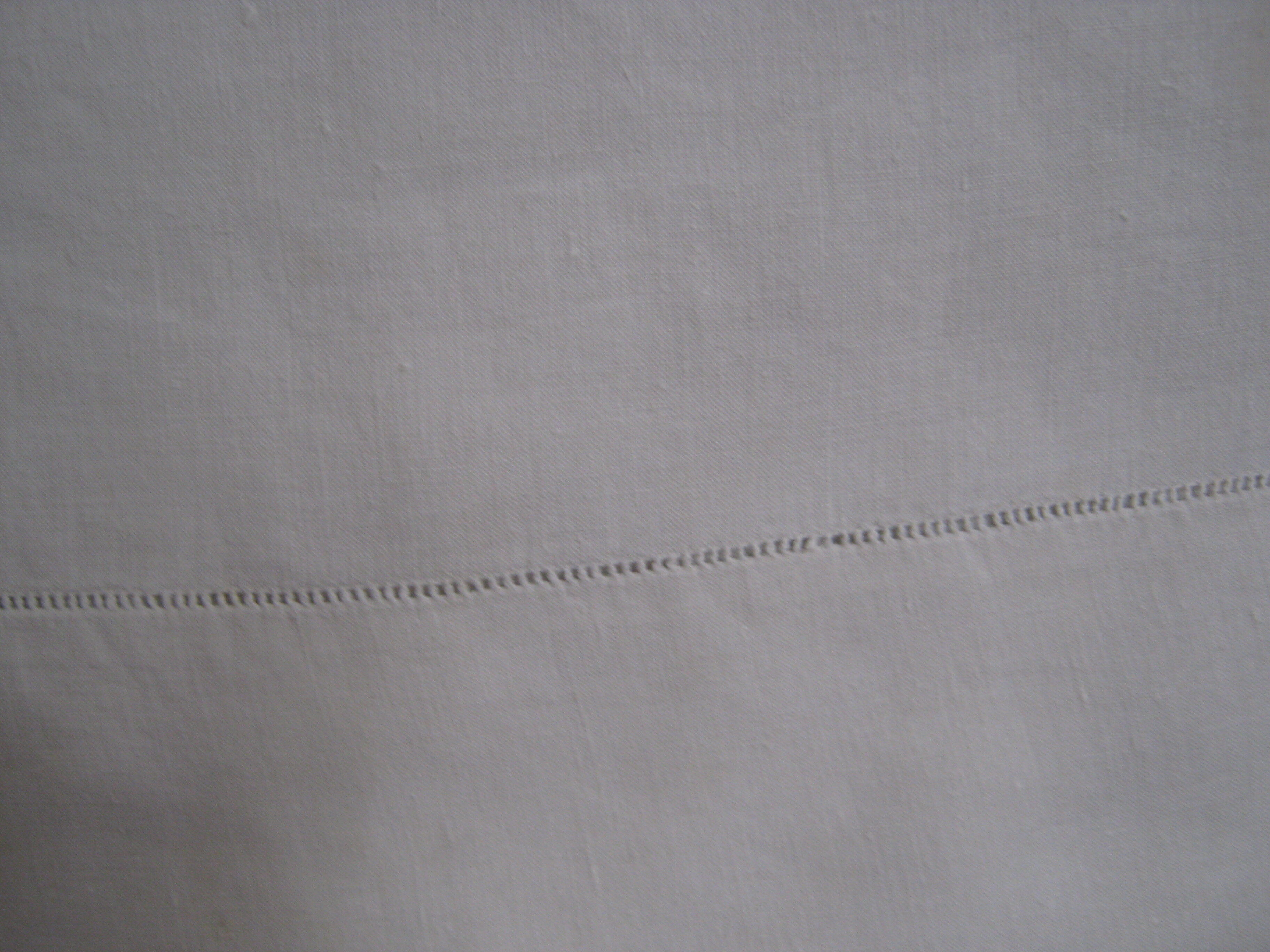 Old sheet in monogram white thread