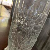 Transparent glass vase with relief floral decoration from the 1980s, fluted neck and polygonal base.