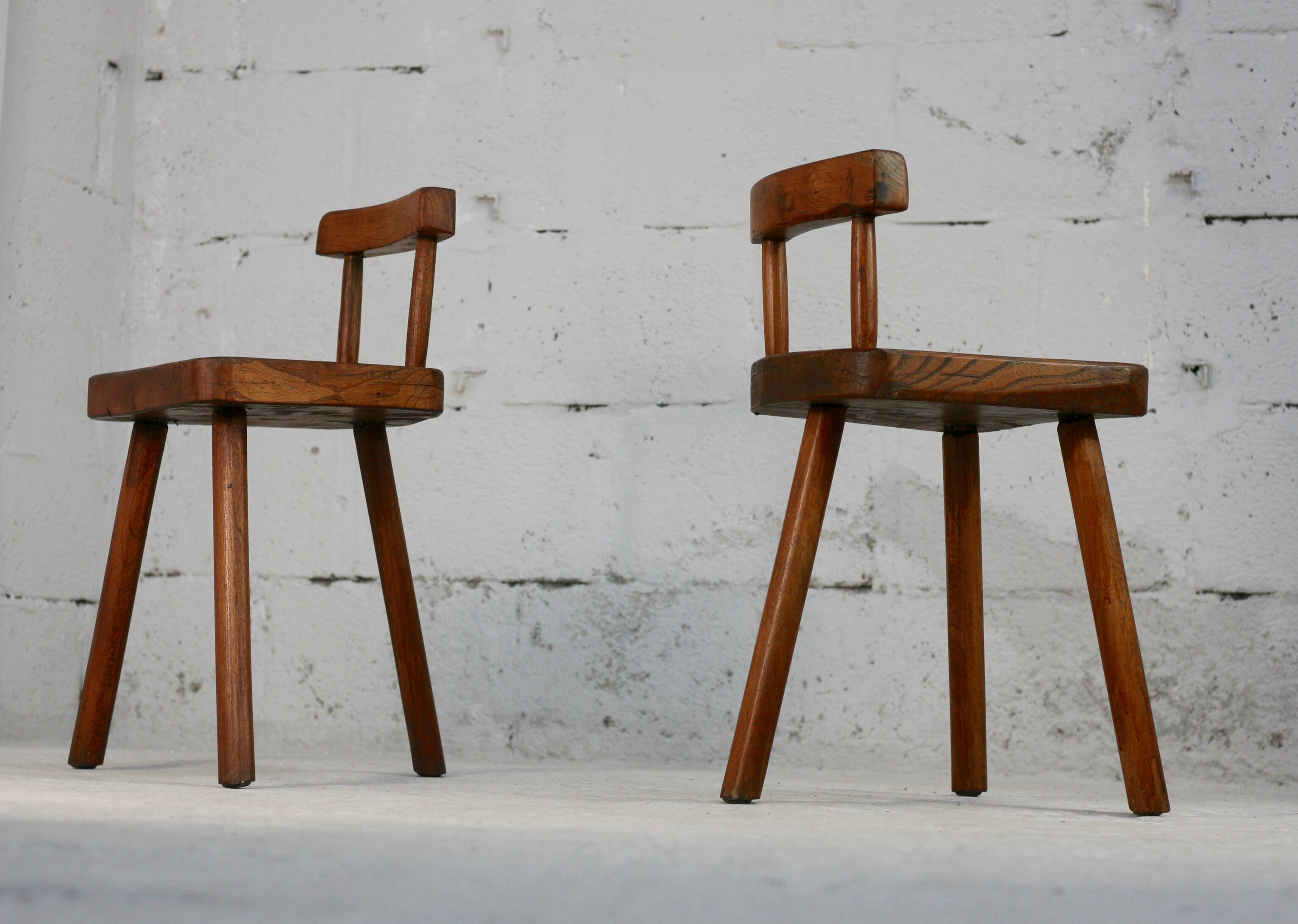 Pair of tripod stools with brutalist backrests, France, circa 1960