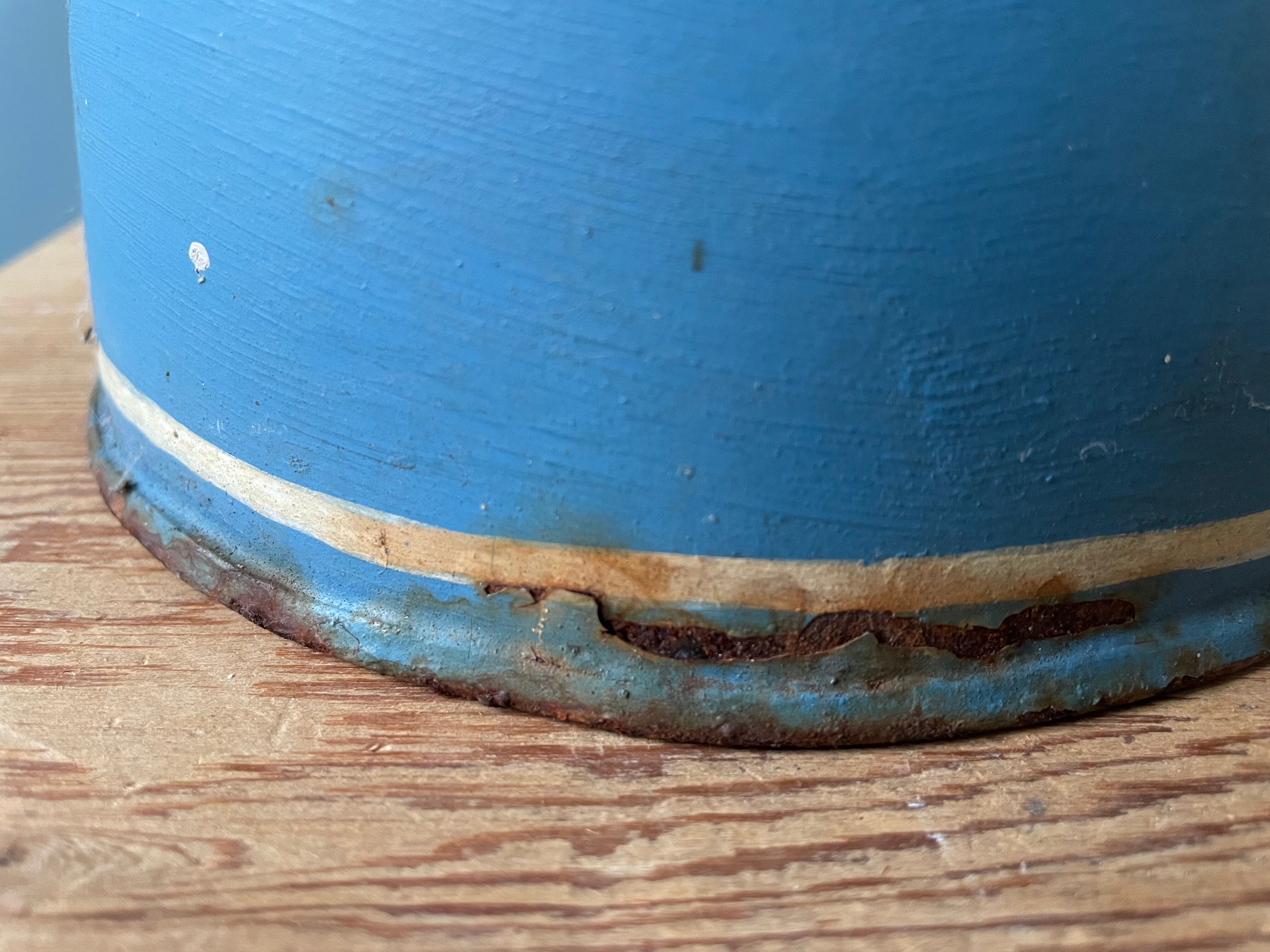 Old painted sheet metal jug or milk jug