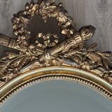 19th century oval gilded mirror, torch & quiver 106cm