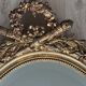 19th century oval gilded mirror, torch & quiver 106cm