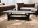 Vintage glass coffee table with dark wood frame