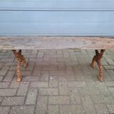 French country style cast iron bench with old rustic wooden plank