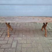 French country style cast iron bench with old rustic wooden plank