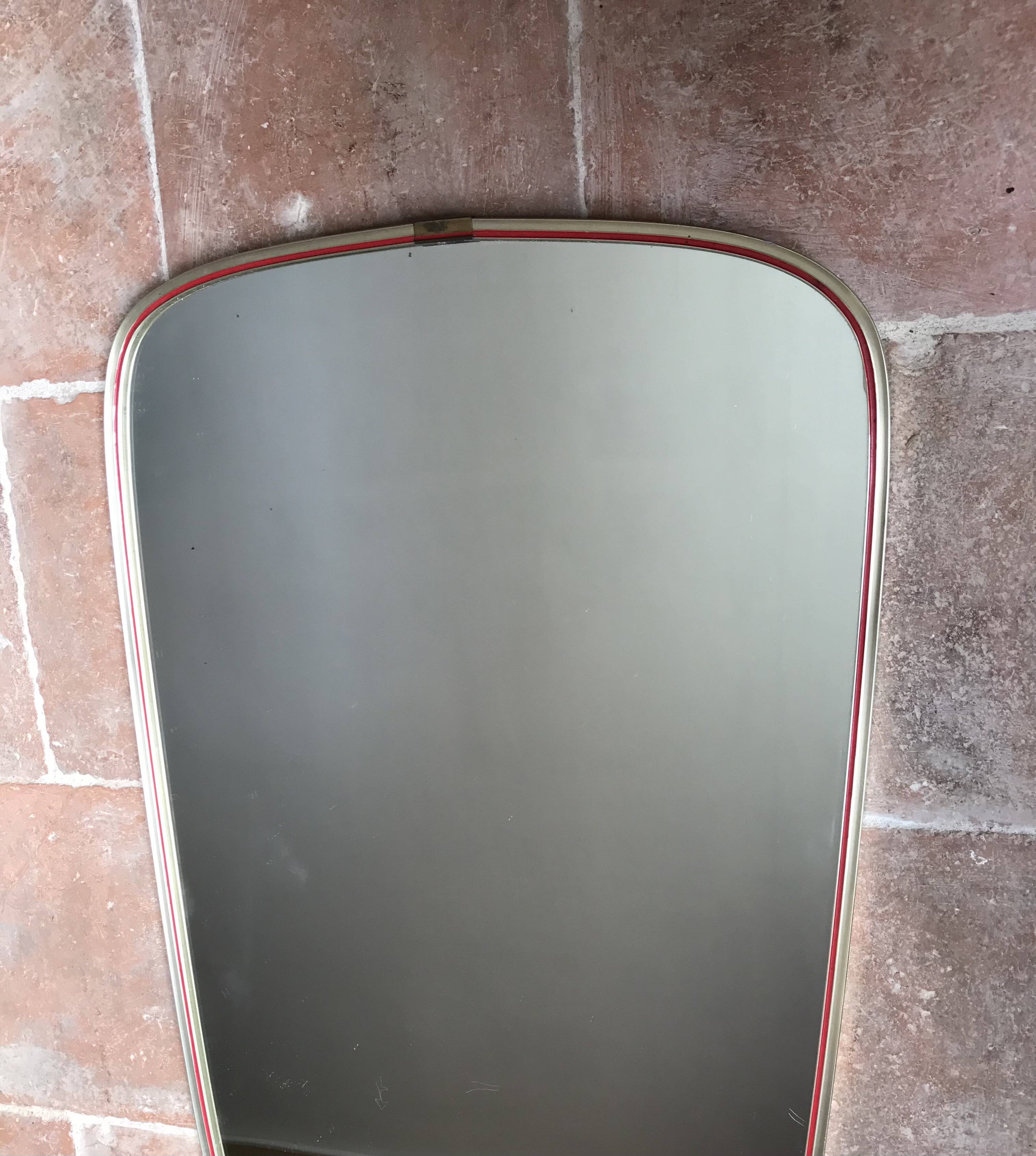 Vintage 1960s mirror in a freeform shape with a gold and red trim.