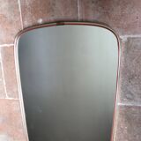 Vintage 1960s mirror in a freeform shape with a gold and red trim.