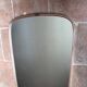 Vintage 1960s mirror in a freeform shape with a gold and red trim.
