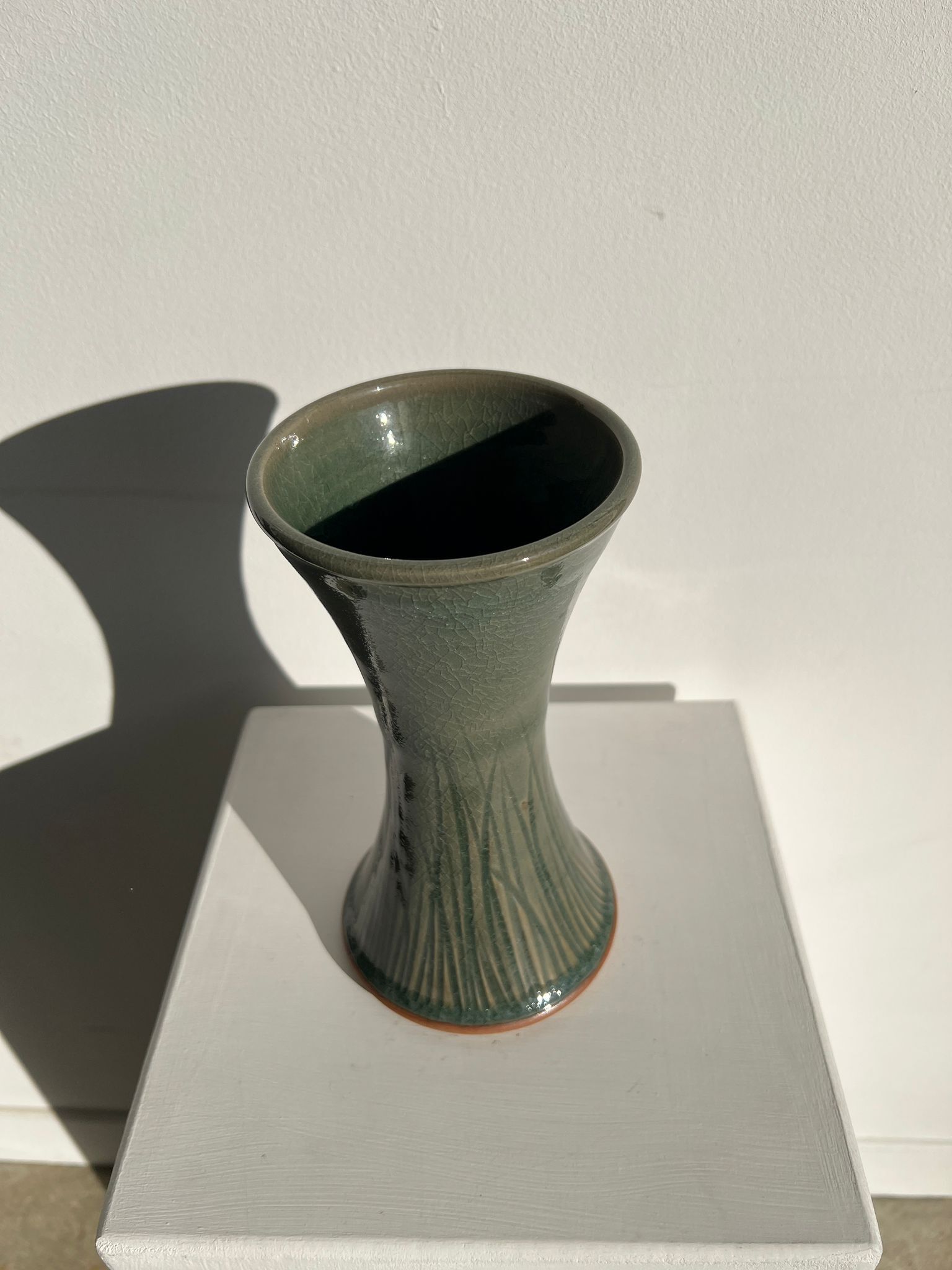 Dark green handcrafted vase with glazed ceramic grass blades