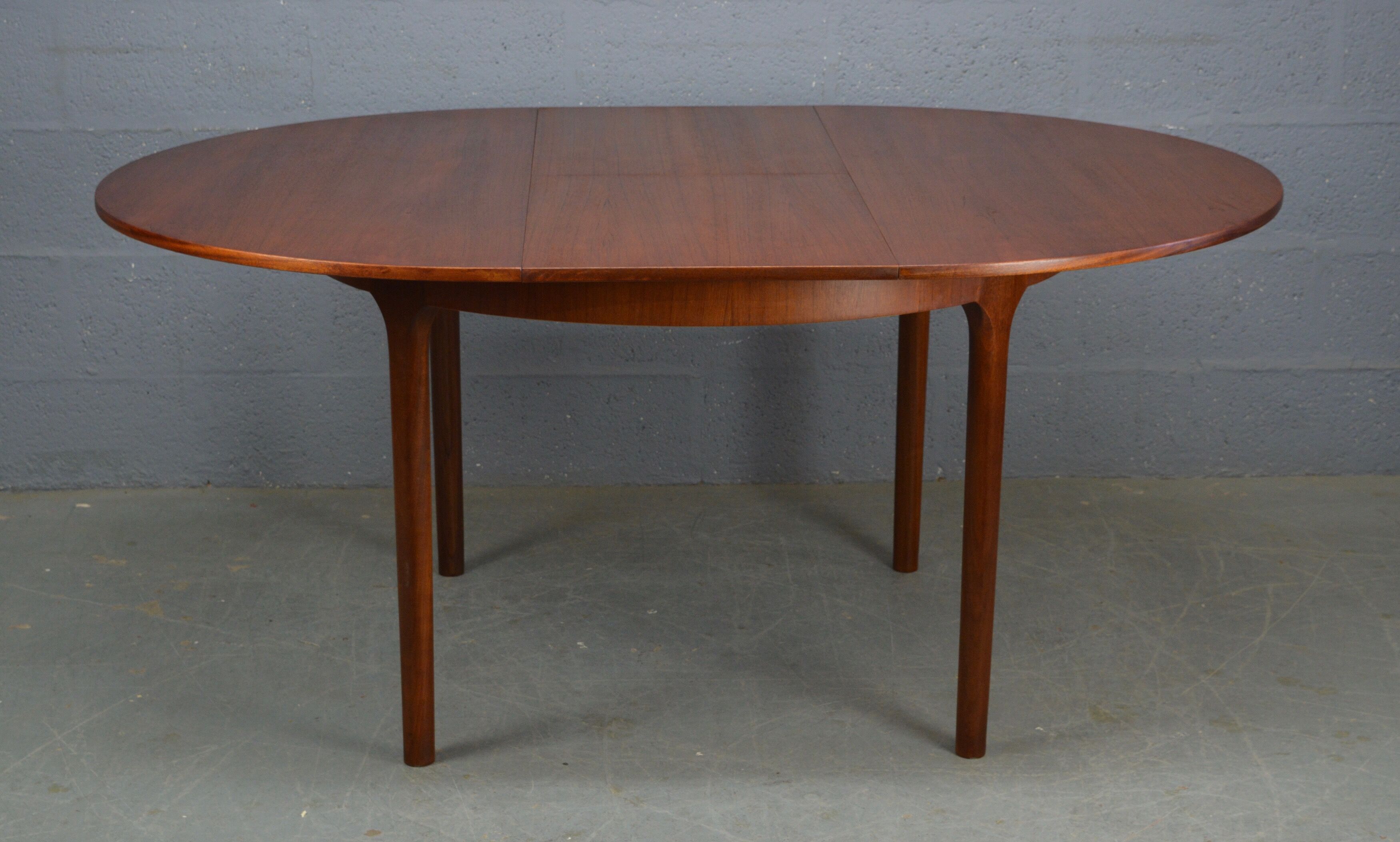 Round teak dinning table and chairs by Mctintosh
