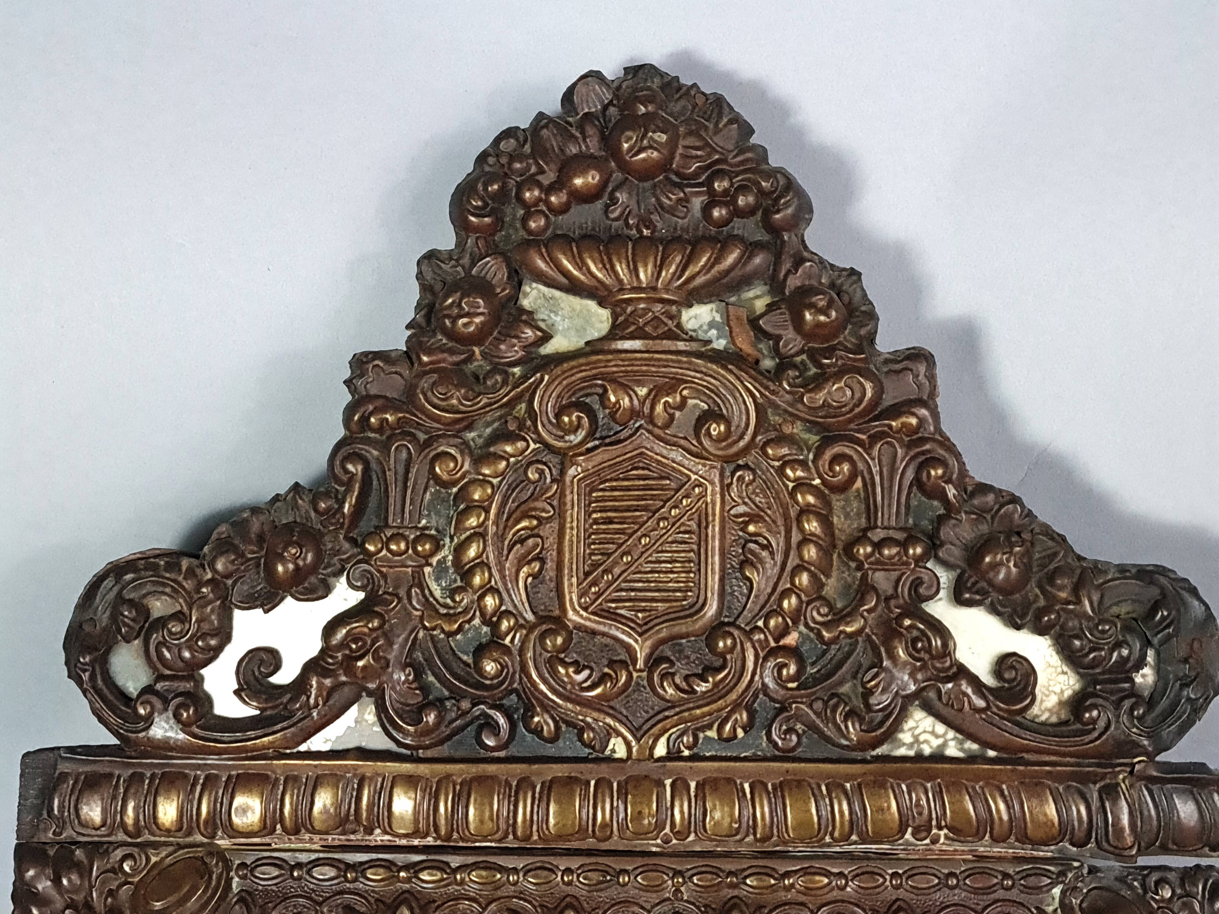 Antique brass repoussé mirror with wooden backing, 59x31 cm, C831.