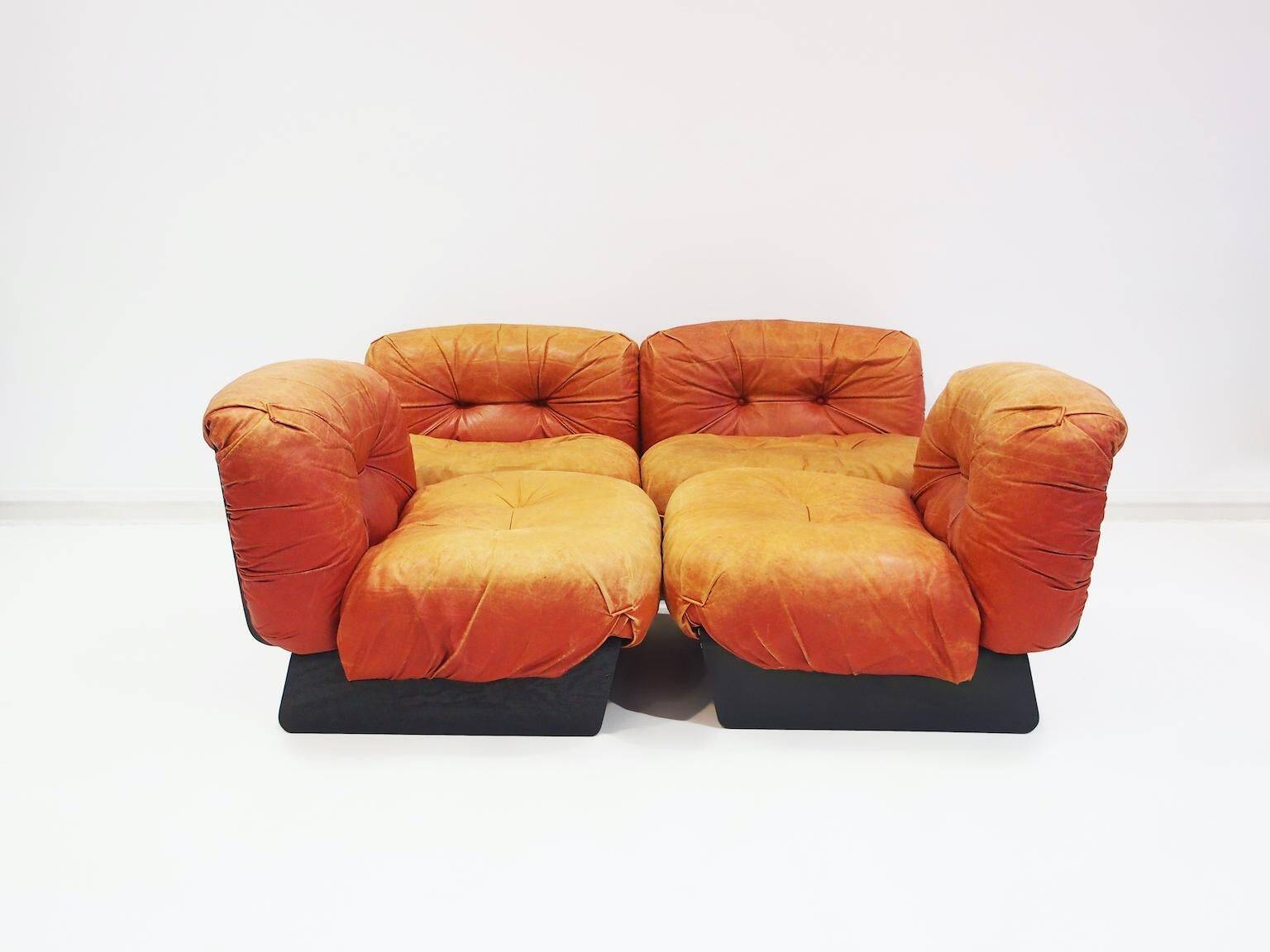 Set of four modular sun loungers by Giuseppe Munari upholstered in cognac leather.