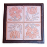 Ceramic tile trivet with floral patterns in pastel tones.