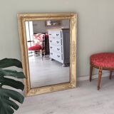 Wood and gilded stucco mirror, 19th century, 115 x 61.5 cm.