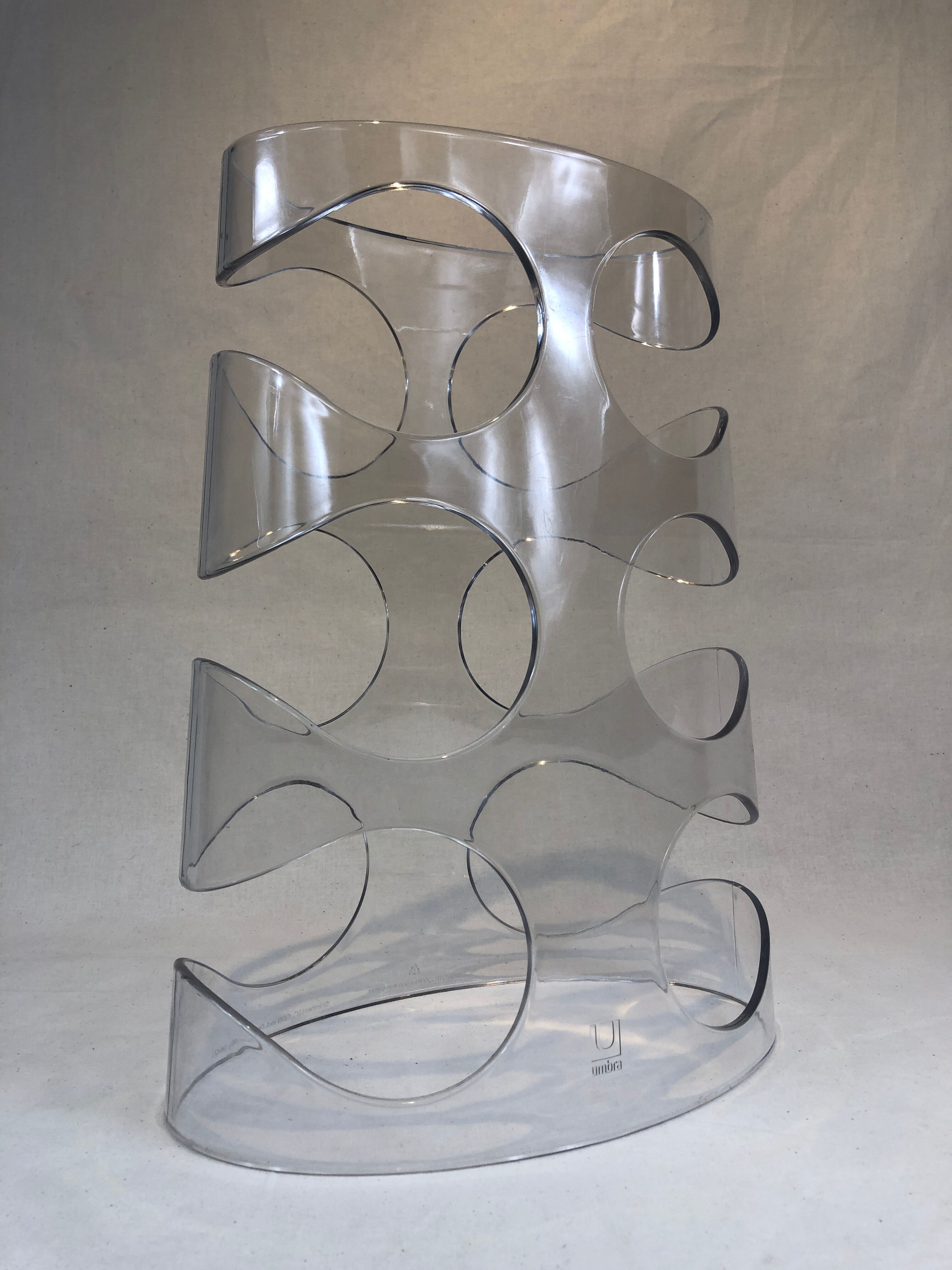 Transparent plexiglass bottle holder Umbra design Ran Lerner