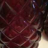 2 red molded glass bottles or jars