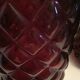 2 red molded glass bottles or jars