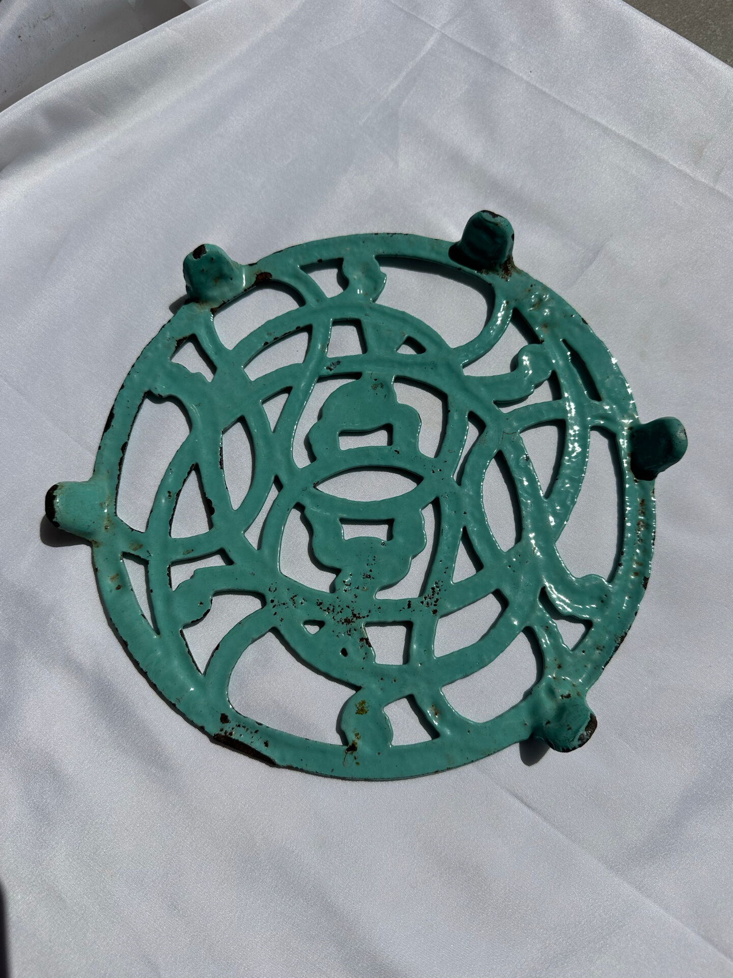 Enamelled cast iron trivet in blue with wrought iron decoration.