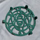 Enamelled cast iron trivet in blue with wrought iron decoration.