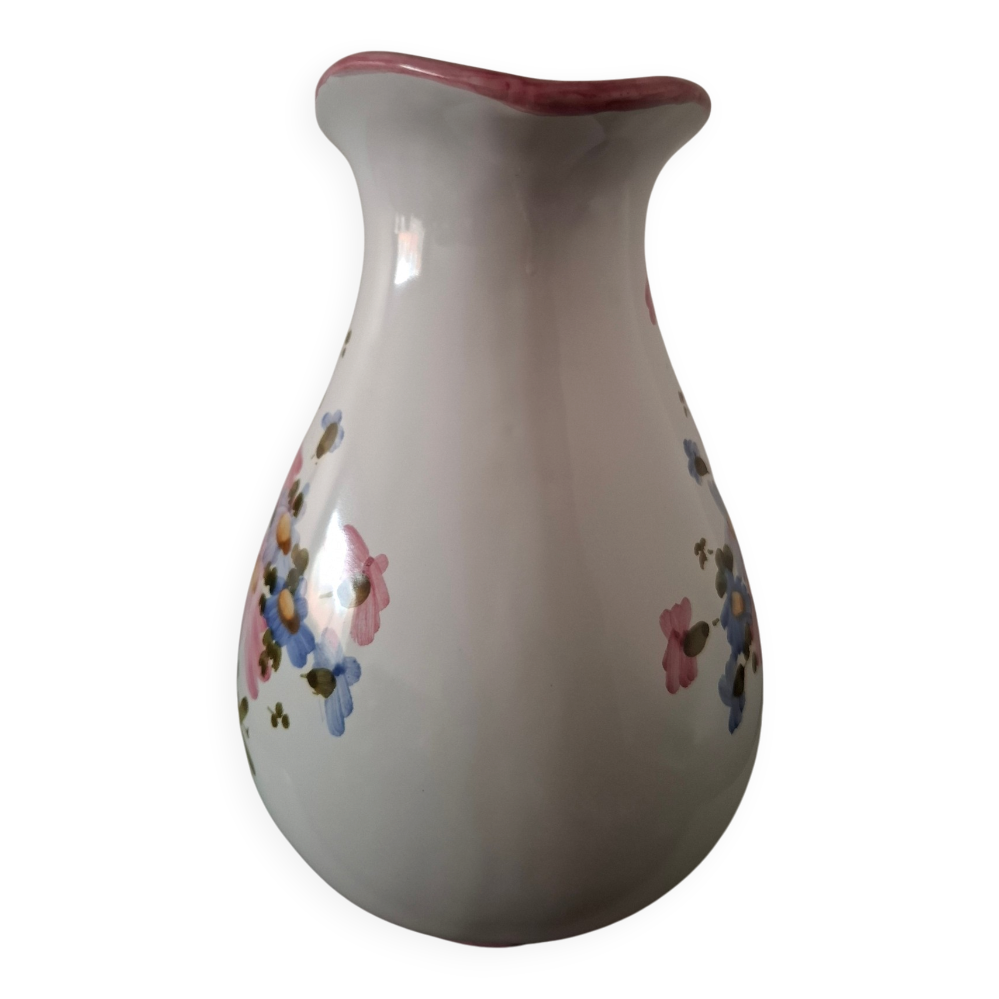 Old ceramic pitcher with floral decoration.