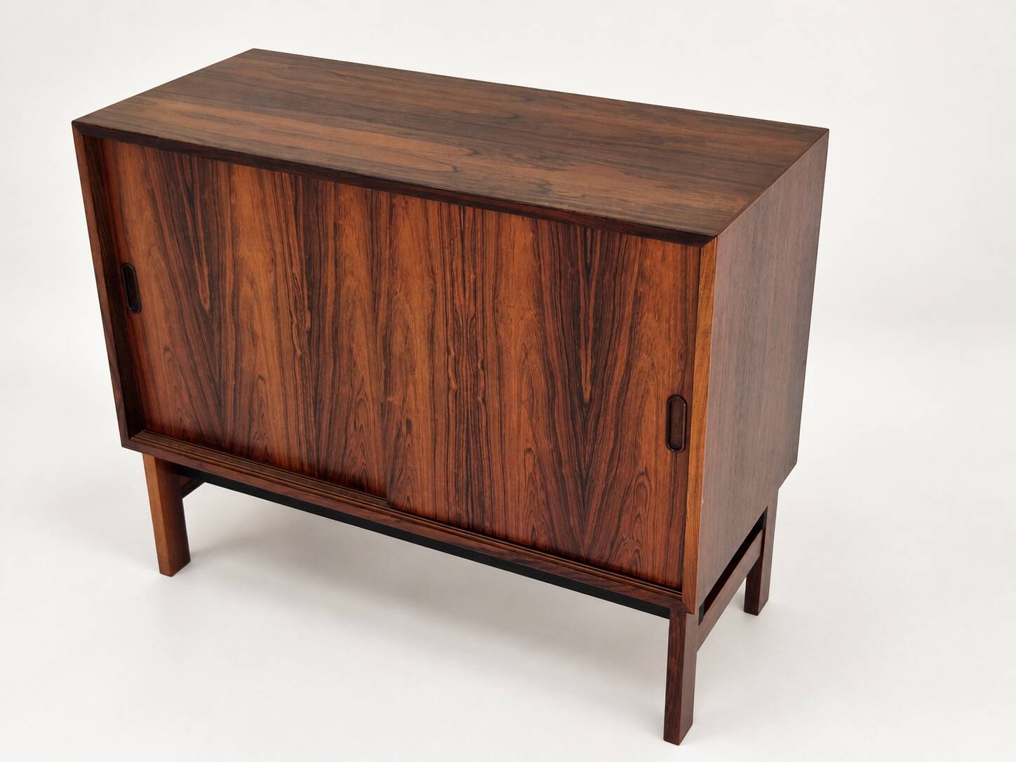 Low sideboard in rosewood with sliding doors. Denmark, 1960s
